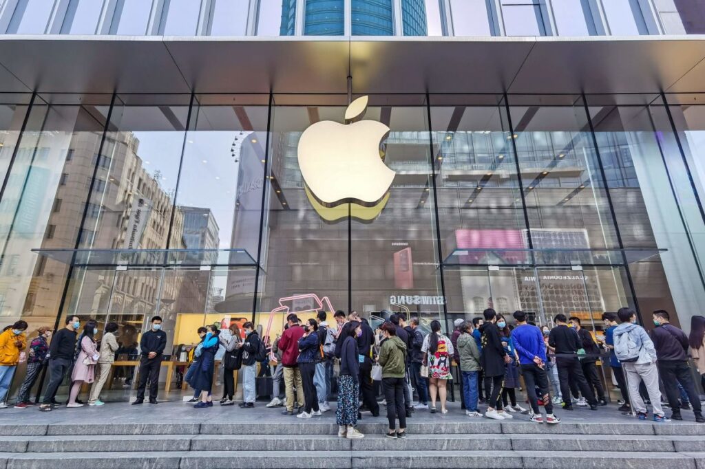 people queuing outside an Apple Store
